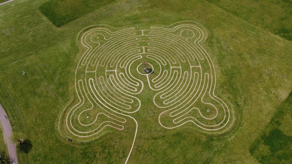 Aerial shot of a grass labyrinth in a green park in Milton Keynes. Perfect for design inspiration.